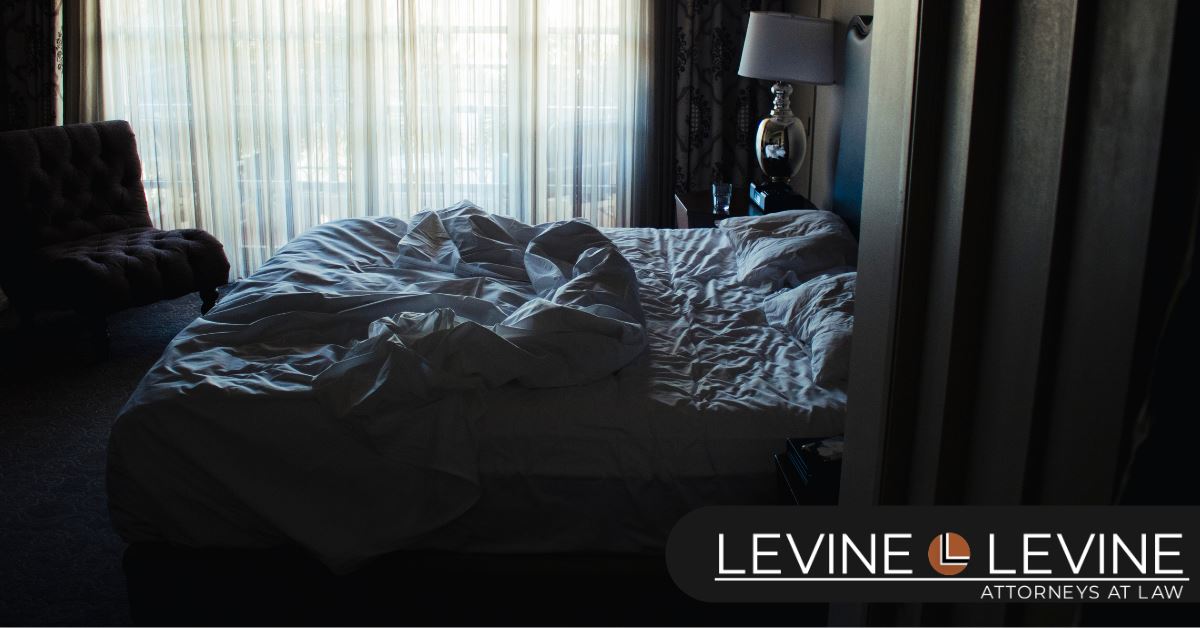 unmade bed in darkly lit room